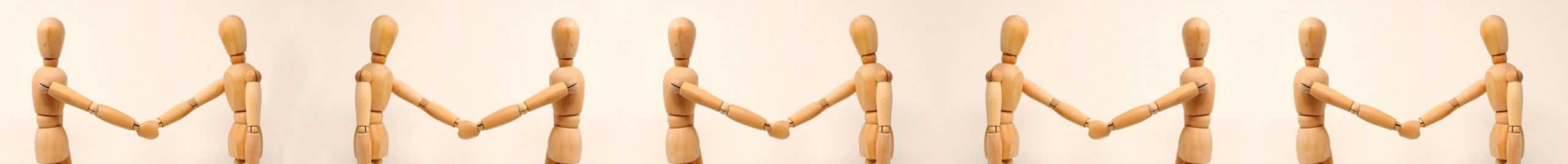 human wooden dolls shake hands